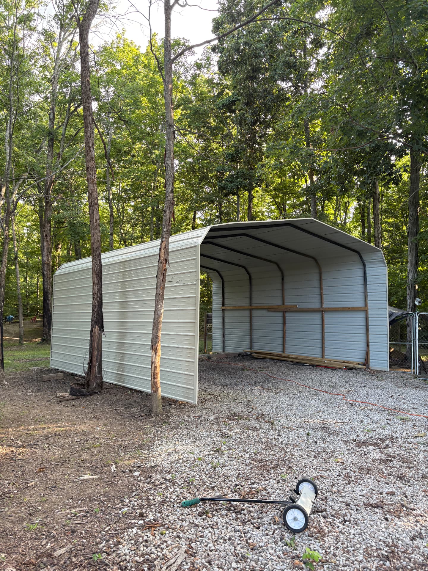 White metal carport installed over gravel driveway in Frankfort, KY