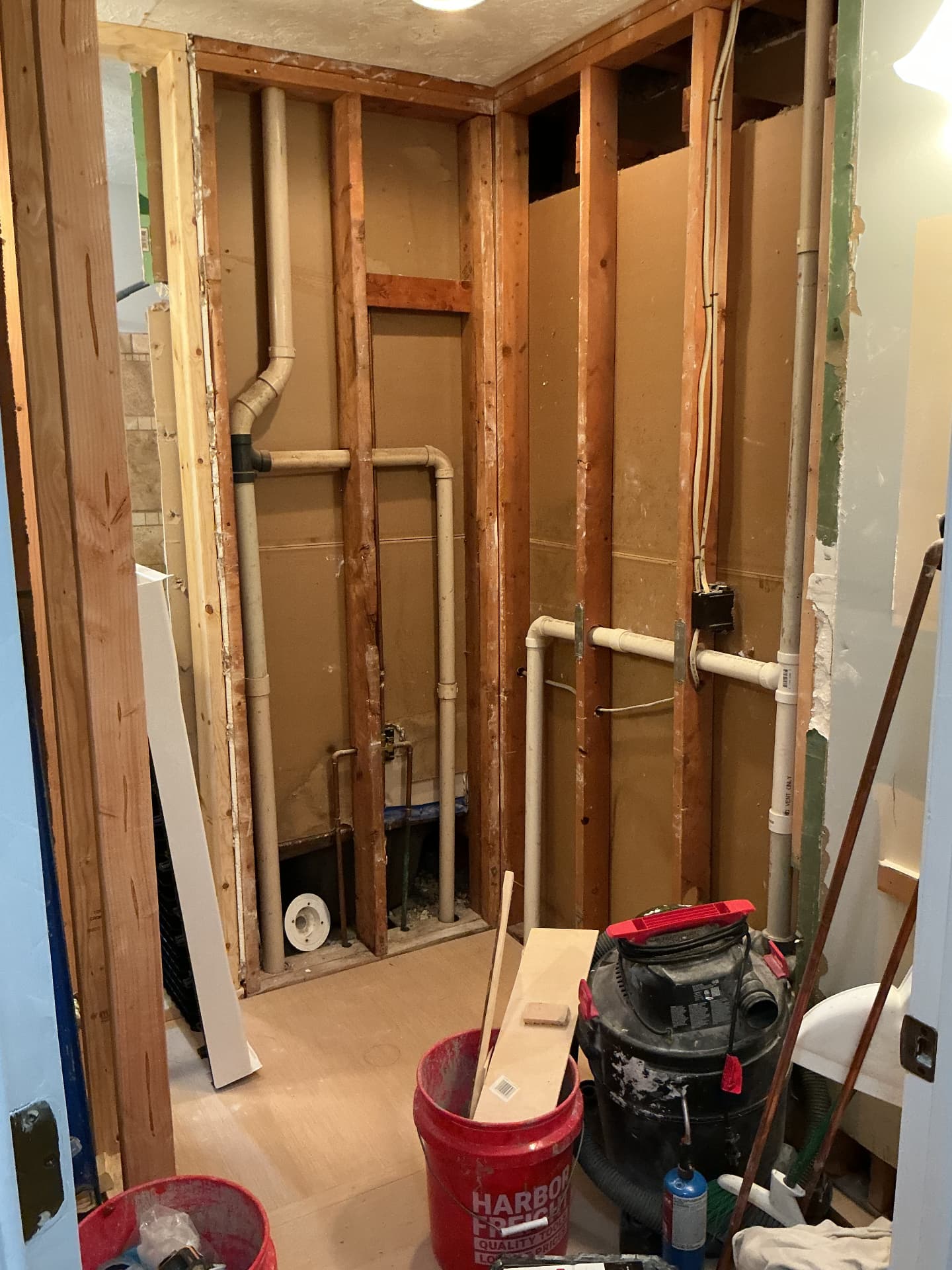 Bathroom demolition down to the wall studs with exposed plumbing in Georgetown, KY