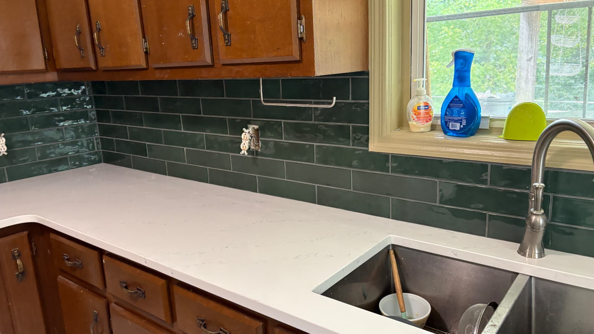 Finished kitchen with dark wood cabinets and green subway tile backsplash in Frankfort, KY
