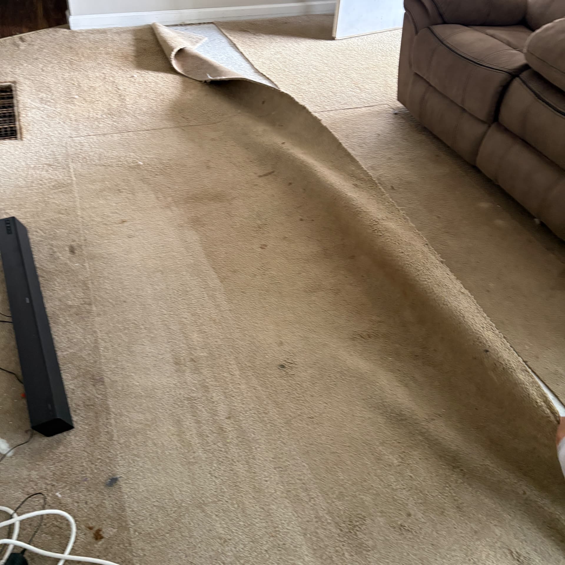 Old carpet being pulled up before new flooring installation in Frankfort, KY