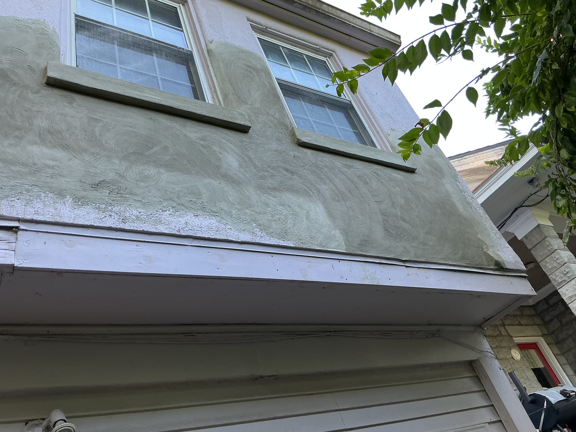 Exterior stucco repair around upper-story windows in Frankfort, KY