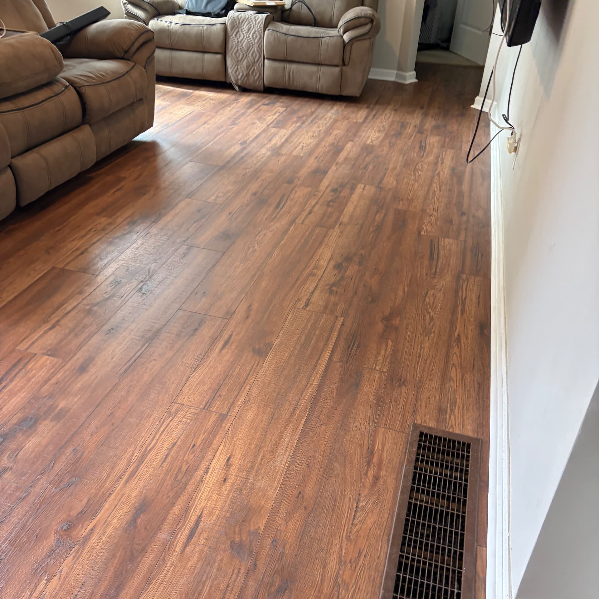 Finished wood-look plank flooring with matching vent cover in Frankfort, KY